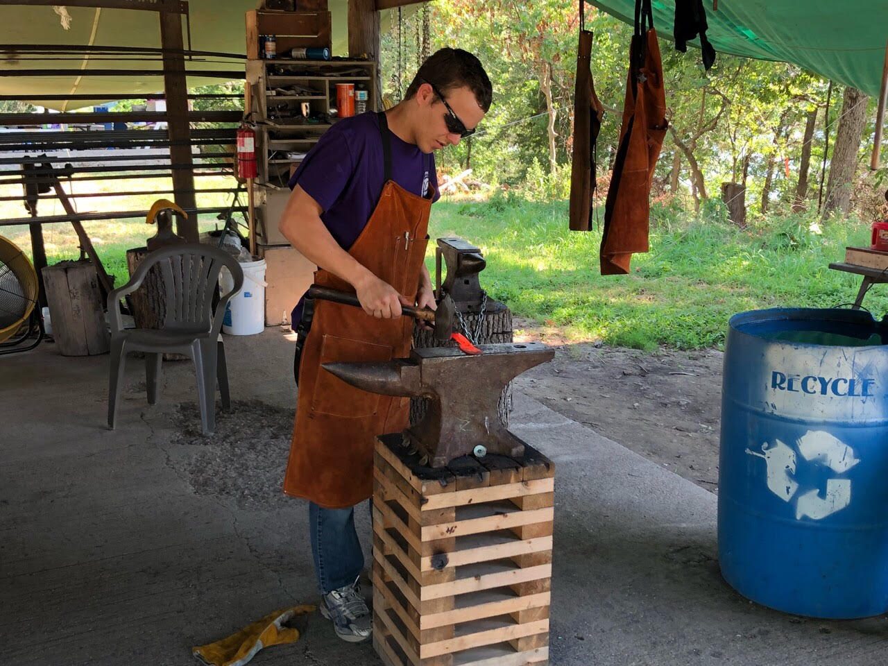 Scout working at the anvil during blacksmithing at LOTOSR