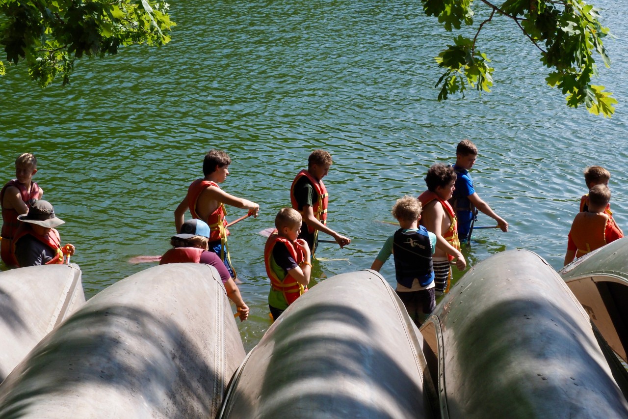 Scouts launching canoes at the lakefront